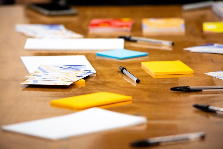 A photo of brightly coloured stationery on a wooden table