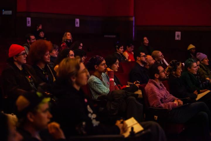 A group of people in the Artsadmin Theatre listening to a talk