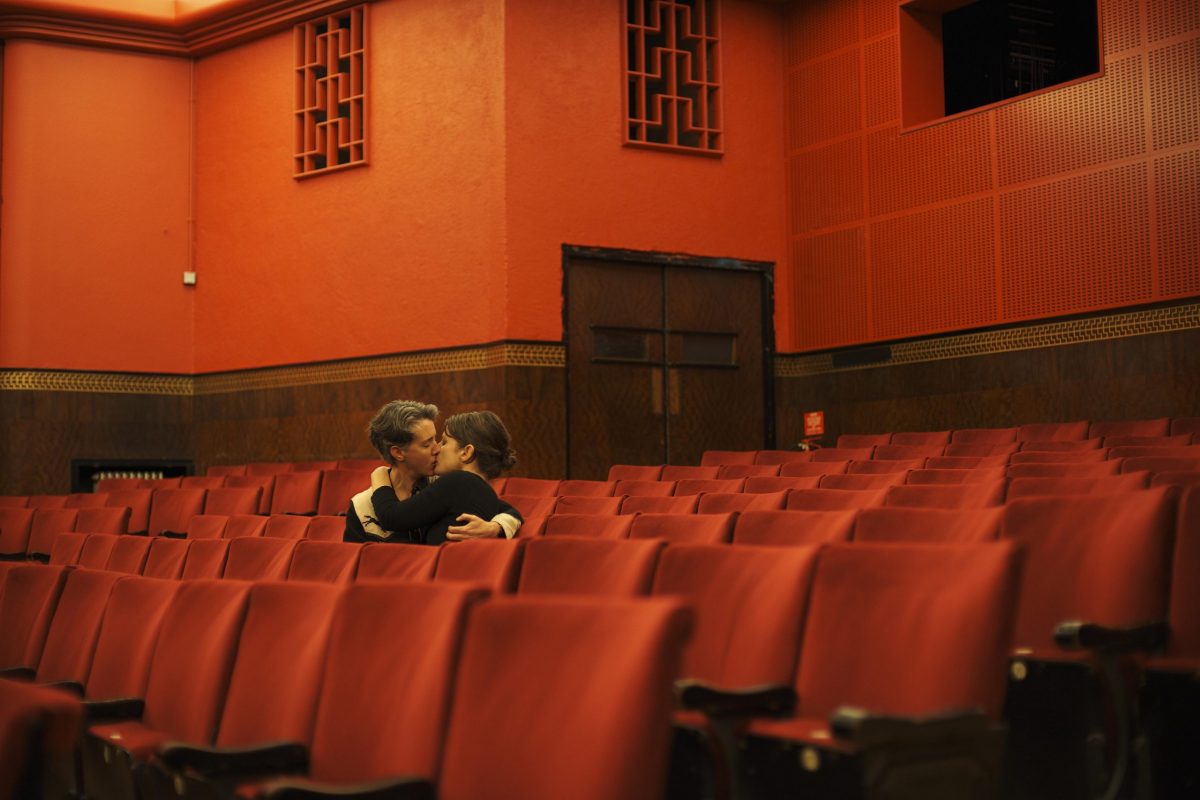 Couple kiss in an empty theatre