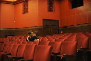 Couple kiss in an empty theatre