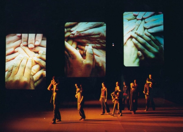 performers on stage with projections