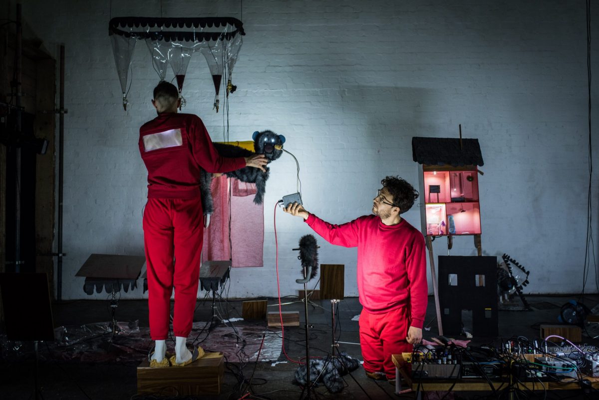 two people in a laboratory creating with random objects