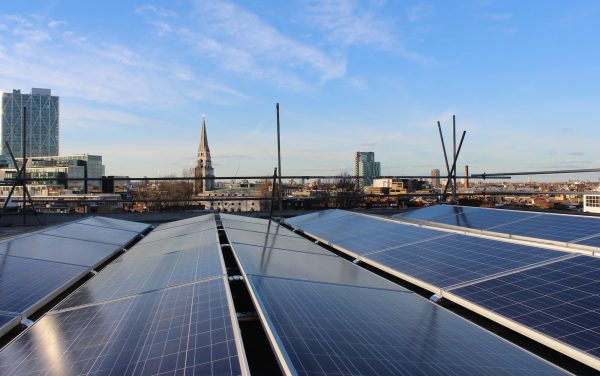 Solar panels on the roof against the city skyline