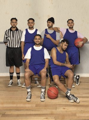 an image of basketball team. The image has five players and one referee which are all the same person in different characters.