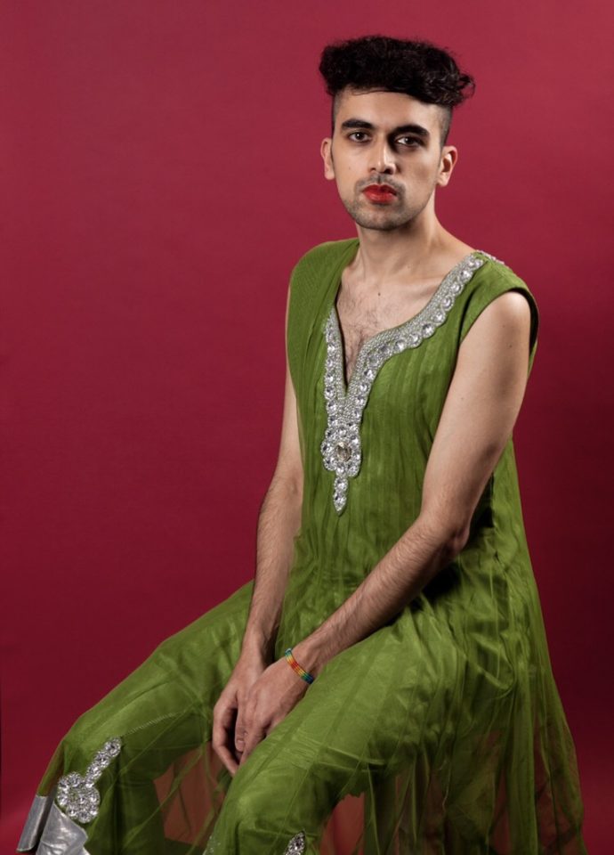 Portrait of Vijay in a sari sitting looking at the camera