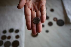 Hand holding a coin