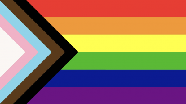 Pride rainbow flag with black and brown stripes to represent marginalised LGBT communities of colour, along with the colours pink, light blue and white, which are used on the Transgender Pride Flag.