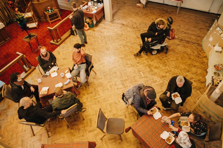 birds eye view of people sat at tables eating and talking