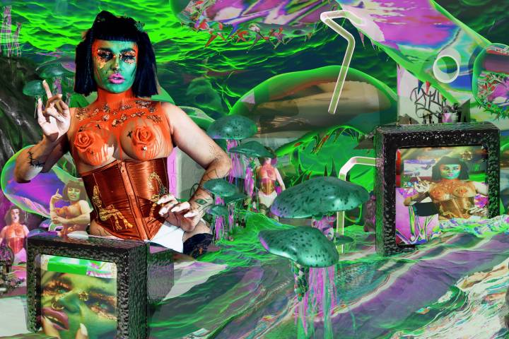 A swirling gloopy wave of neon greens, blues and purples surrounds a series of photo-collage images including green jellyfish, mushrooms, straws and analogue televisions. There are smaller images of Oozing Gloop in different poses on the television screens and in the background of the waves. On the left side is a picture of Oozing Gloop, a drag artist with a black-bob wig, green face, green snake eyes, gold leaf eye make-up, fuchsia lip and gold bullring. Gloop is wearing a bronze corset with gold embroidery, with a high-neck coral neck-piece that drips over exposed breasts with coral roses covering the nipples. Gloop has a salty expression and is holding their hands as if mid-sentence.