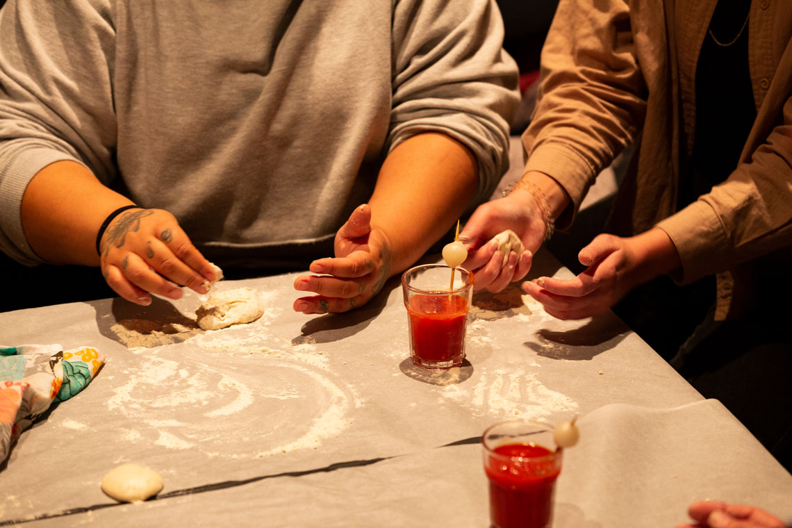 The guests hands as they knead bread at the table