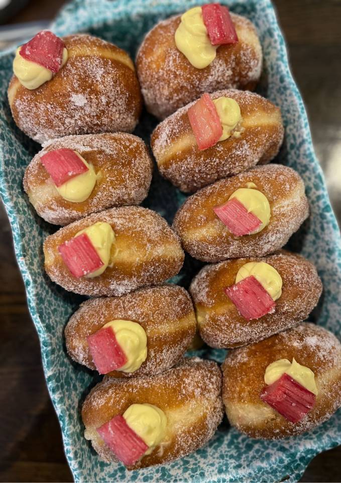 A photo of a box of rhubarb and custard donuts